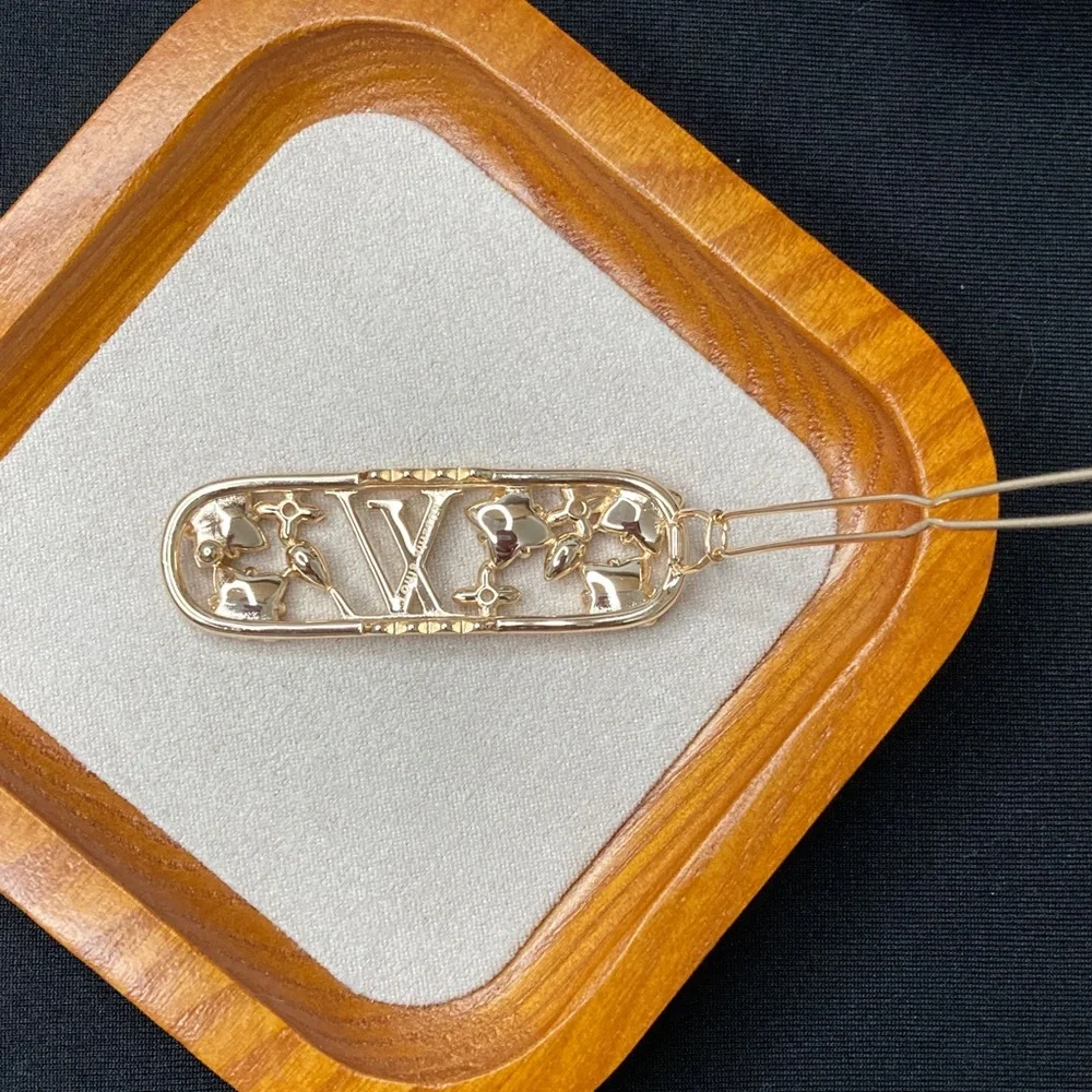 Louis Vuitton Gold Hair Clip with Red, Pink, and Silver Stars - Picture 2 of 3